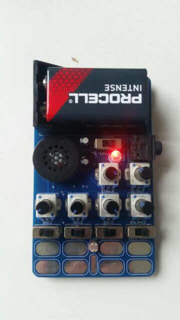 t24_bugbrand - a small board, almost card-sized, with a 9V battery, touchplates, potis, an LED and a speaker.